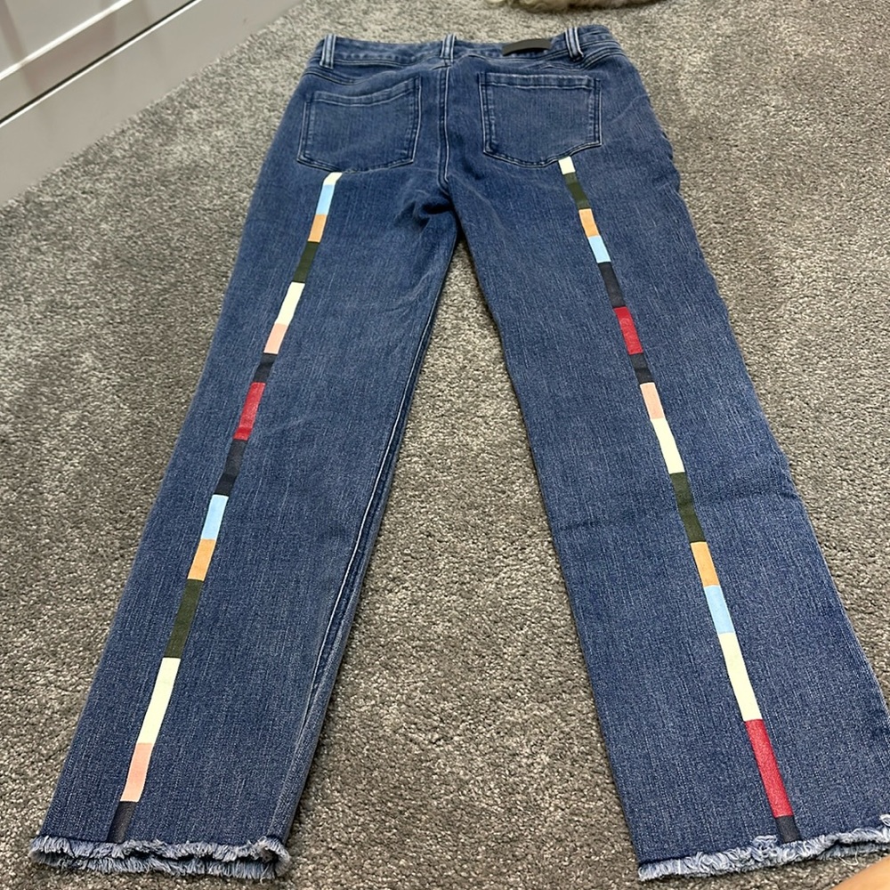 Ecru Jean with multi color stipe going down back of legs.